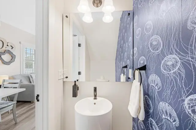 Bathroom vanity at villa 5092 with a round mirror