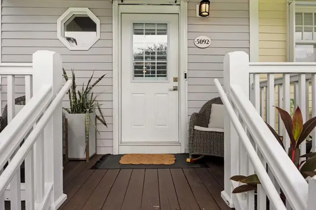 Front door of villa 5092, with a porch and planting either side