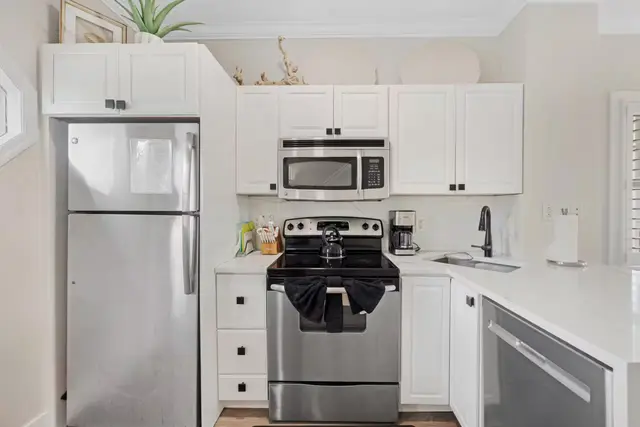 Kitchen at villa 5092 with white cabinets and stainless steel appliances
